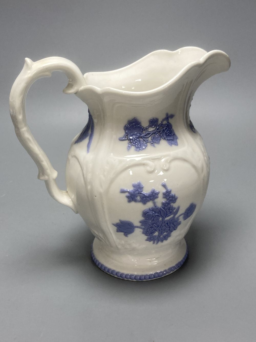 Four early 19th century Staffordshire jugs, each with lilac coloured floral applied panels, one dated 1826, tallest 22cm